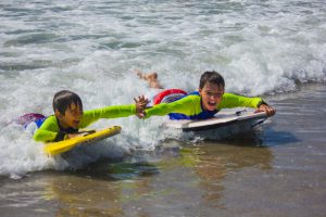 coastal-ocean-odyssey-campers-boogieboarding